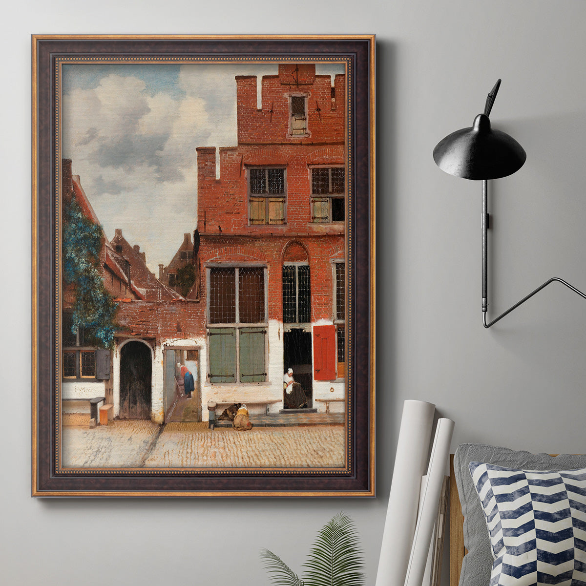 Realist city street scene by Johannes Vermeer in an ornate bronzed mahogany wood frame displayed in a neutral interior setting.