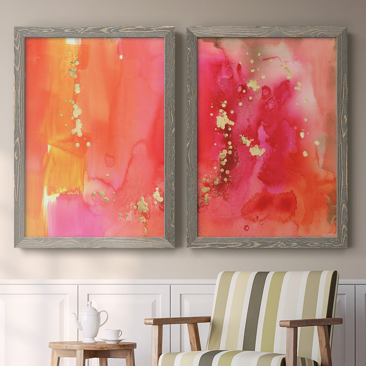 Set of two gray barnwood framed canvas prints depicting two glamorous fluid abstracts featuring luminous coral orange and pink color fields with gold flecks above a sideboard in a cozy sitting room.