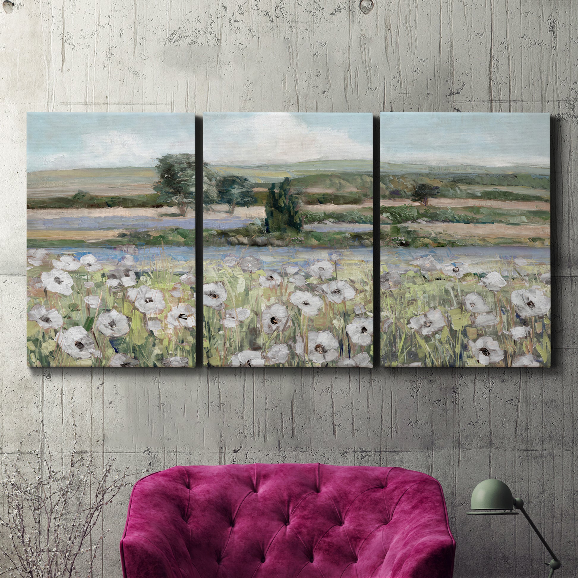 Three-panel canvas wall art featuring vintage poppy filled valley, displayed in a living room above a suede accent chair.