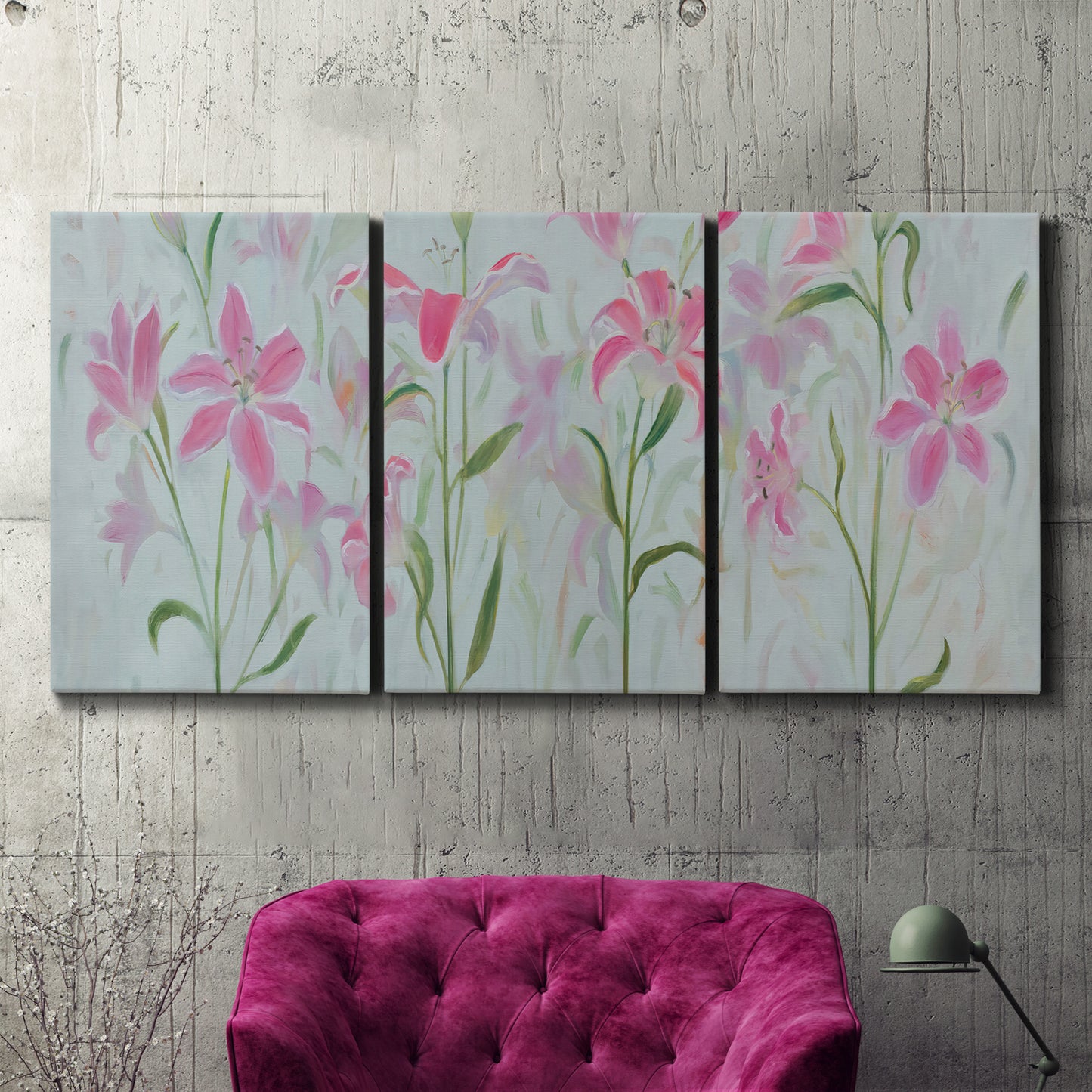Three-panel canvas wall art featuring pink floral trio arrangement, displayed in a living room above a suede accent chair.