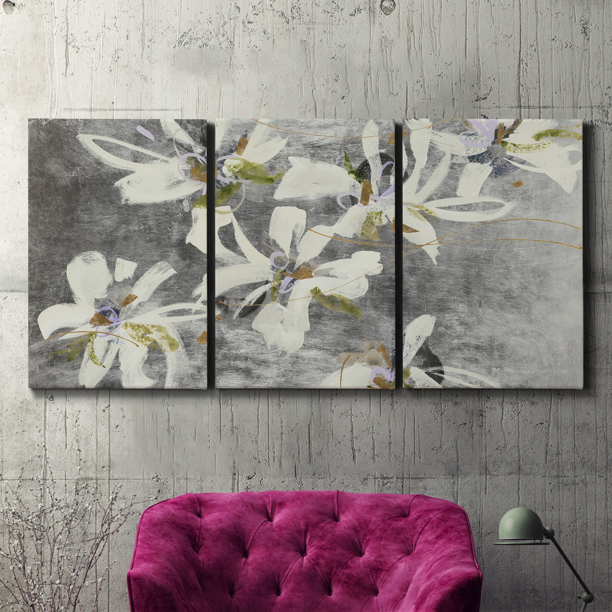 Three-panel canvas wall art featuring delicate floral symbolic arrangement, displayed in a living room above a suede accent chair.