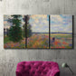 Three-panel canvas wall art featuring poppy field in open countryside, displayed in a living room above a suede accent chair.