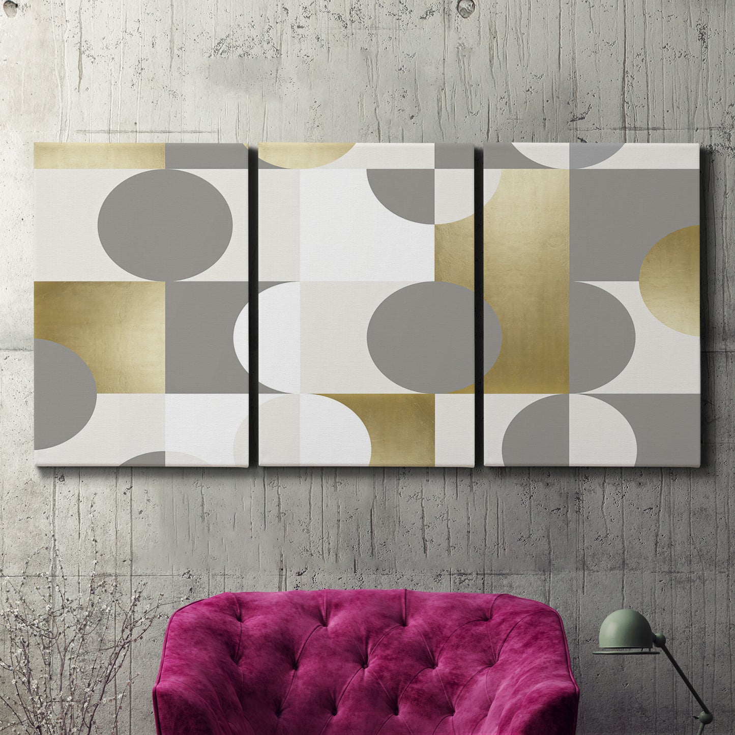 Three-panel canvas wall art featuring geometric gold abstract reflections, displayed in a living room above a suede accent chair.