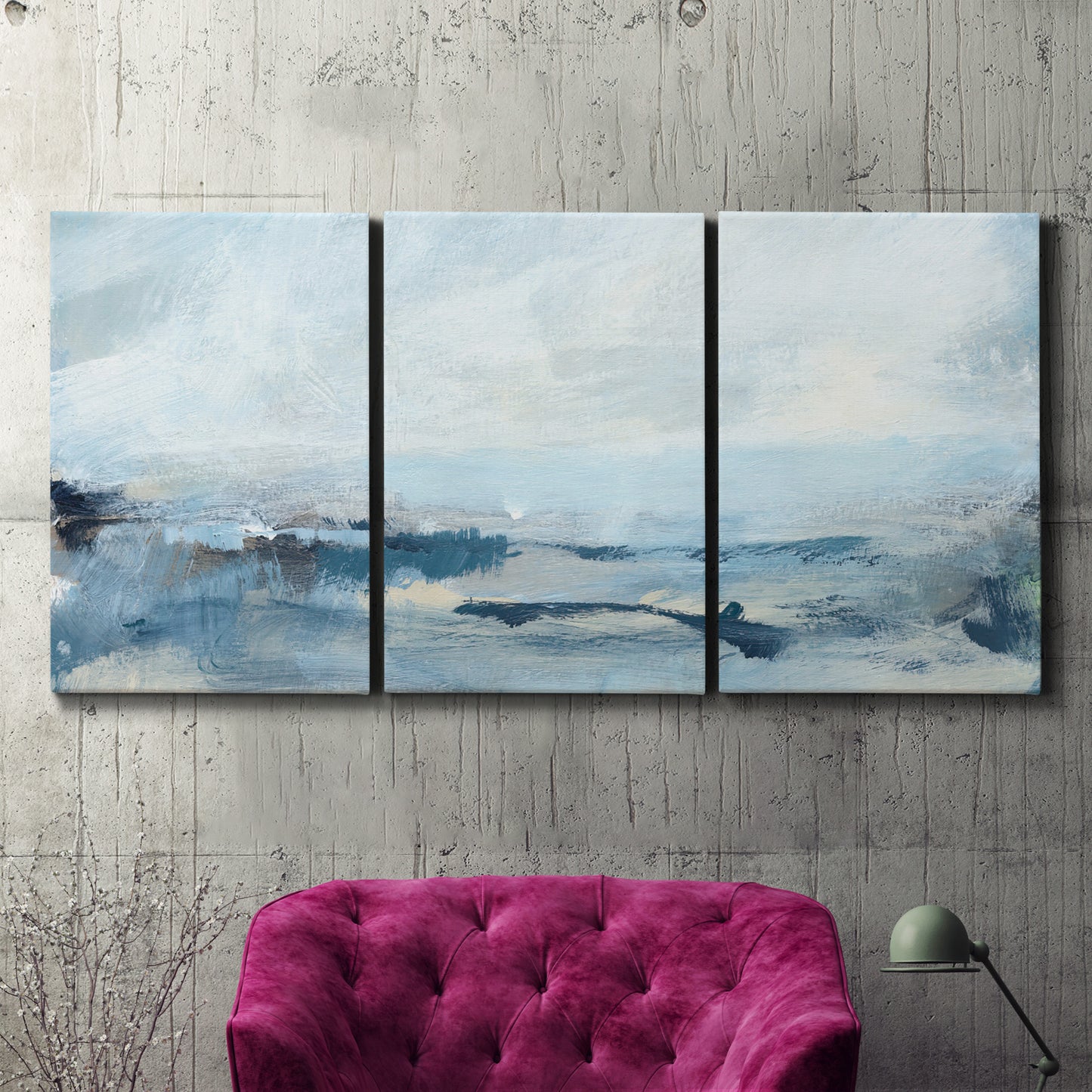 Three-panel canvas wall art featuring abstract sailboats on water, displayed in a living room above a suede accent chair.