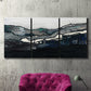 Three-panel canvas wall art featuring abstract passage of time composition, displayed in a living room above a suede accent chair.