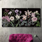 Three-panel canvas wall art featuring early spring blossoms in soft tones, displayed in a living room above a suede accent chair.