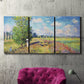 Three-panel canvas wall art featuring sunlit meadow landscape, displayed in a living room above a suede accent chair.