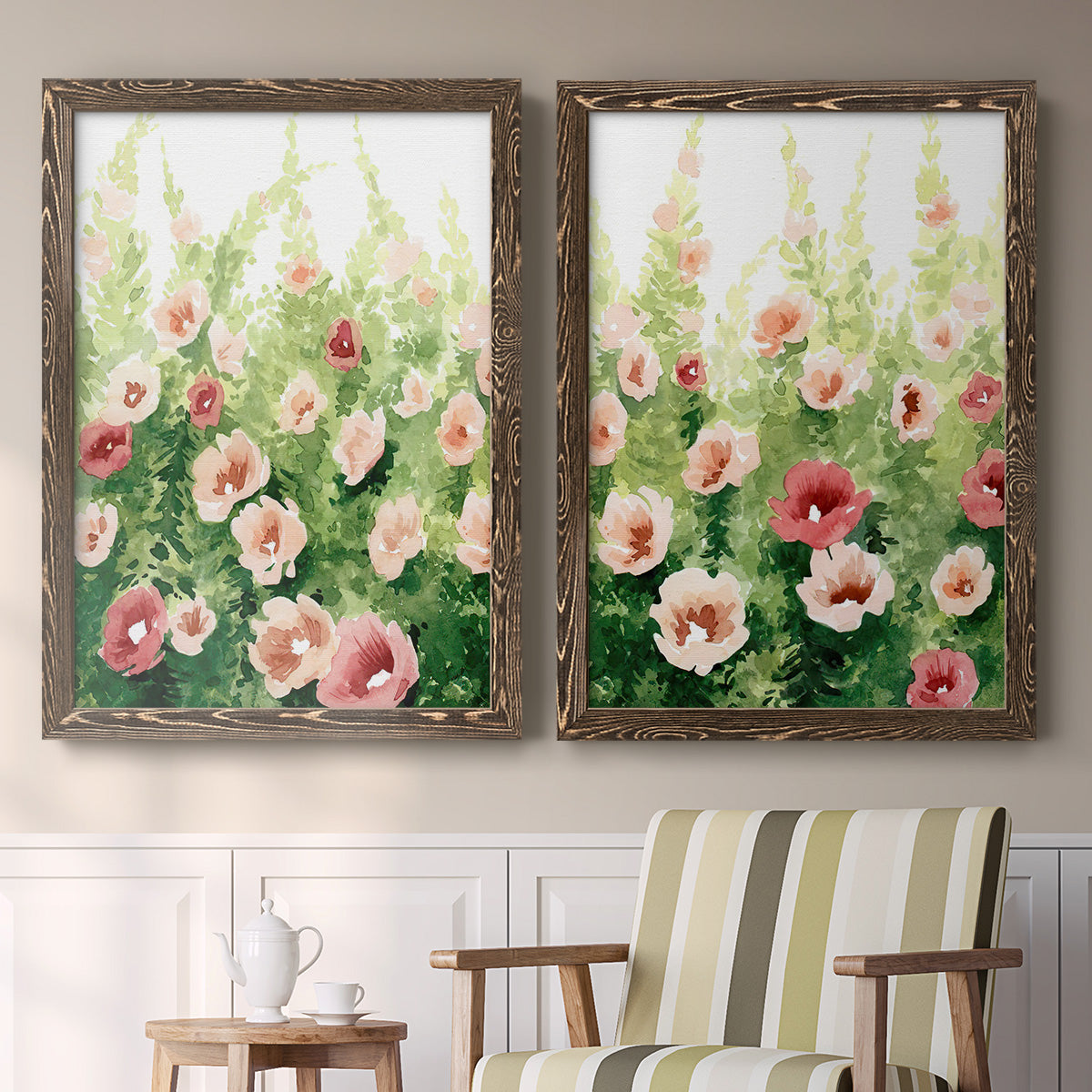 Set of two walnut barnwood framed canvas prints depicting two luminous impressionistic floral paintings featuring a field of pink coral and white flowers above a sideboard in a cozy sitting room.