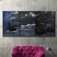 Three-panel canvas wall art featuring dark seascape under night sky, displayed in a living room above a suede accent chair.