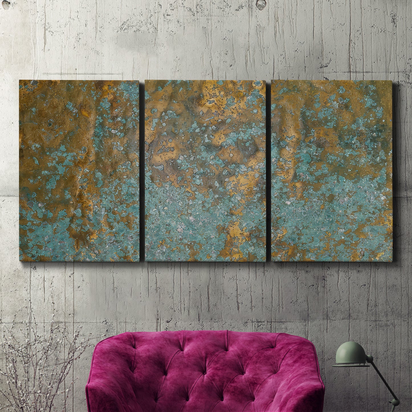 Three-panel canvas wall art featuring earthy copper toned abstract, displayed in a living room above a suede accent chair.