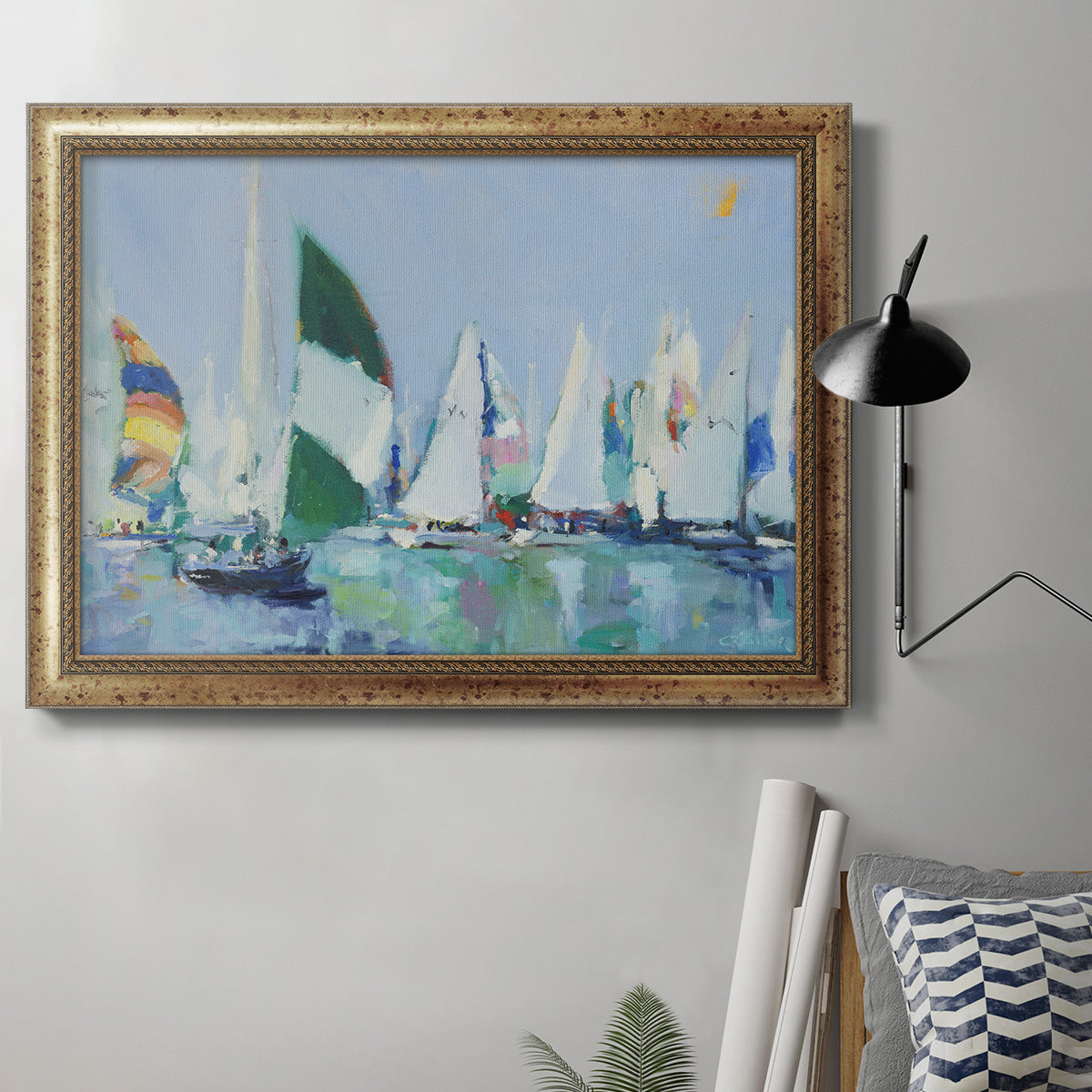Coastal harbor watercolor painting in an ornate vintage gold frame displayed in a neutral interior setting.