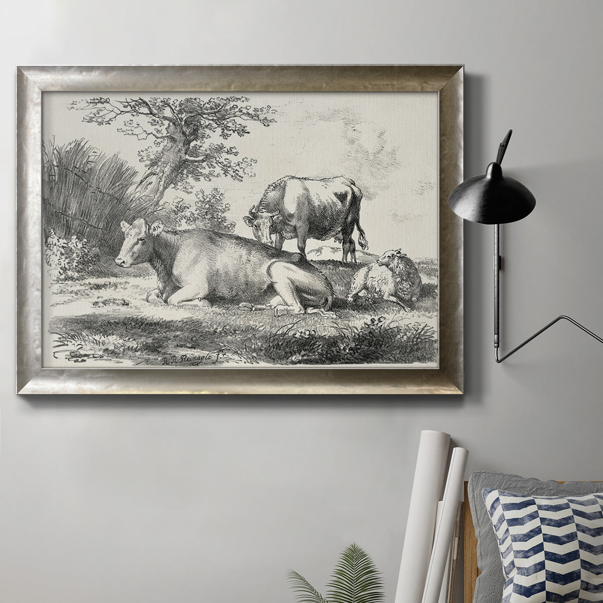 Classical pastoral landscape artwork by Nicolas Berchem in an ornate mottled silver frame displayed in a neutral interior setting.