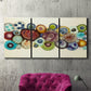 Three-panel canvas wall art featuring mid century geometric red pathway, displayed in a living room above a suede accent chair.