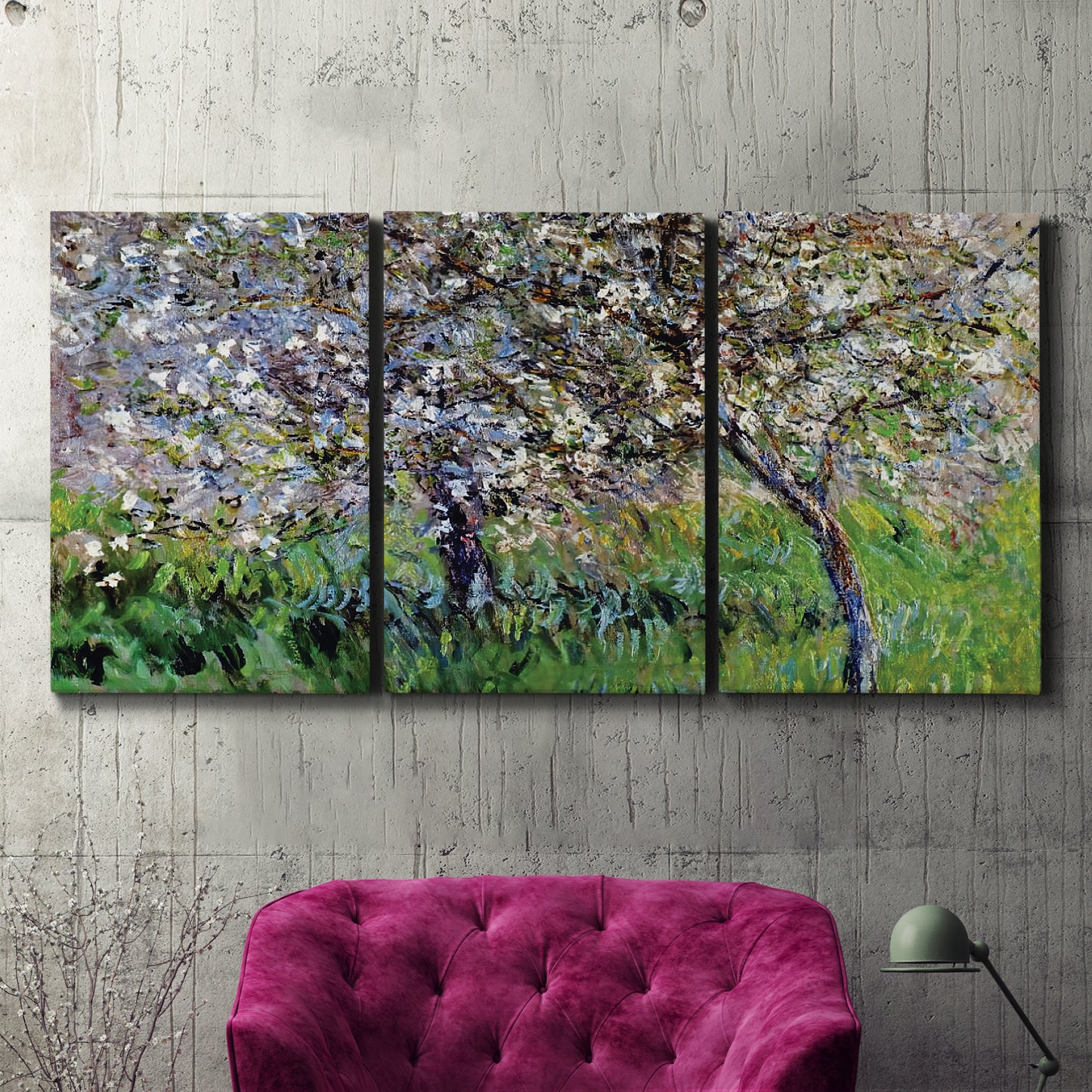Three-panel canvas wall art featuring apple trees blooming beside water, displayed in a living room above a suede accent chair.
