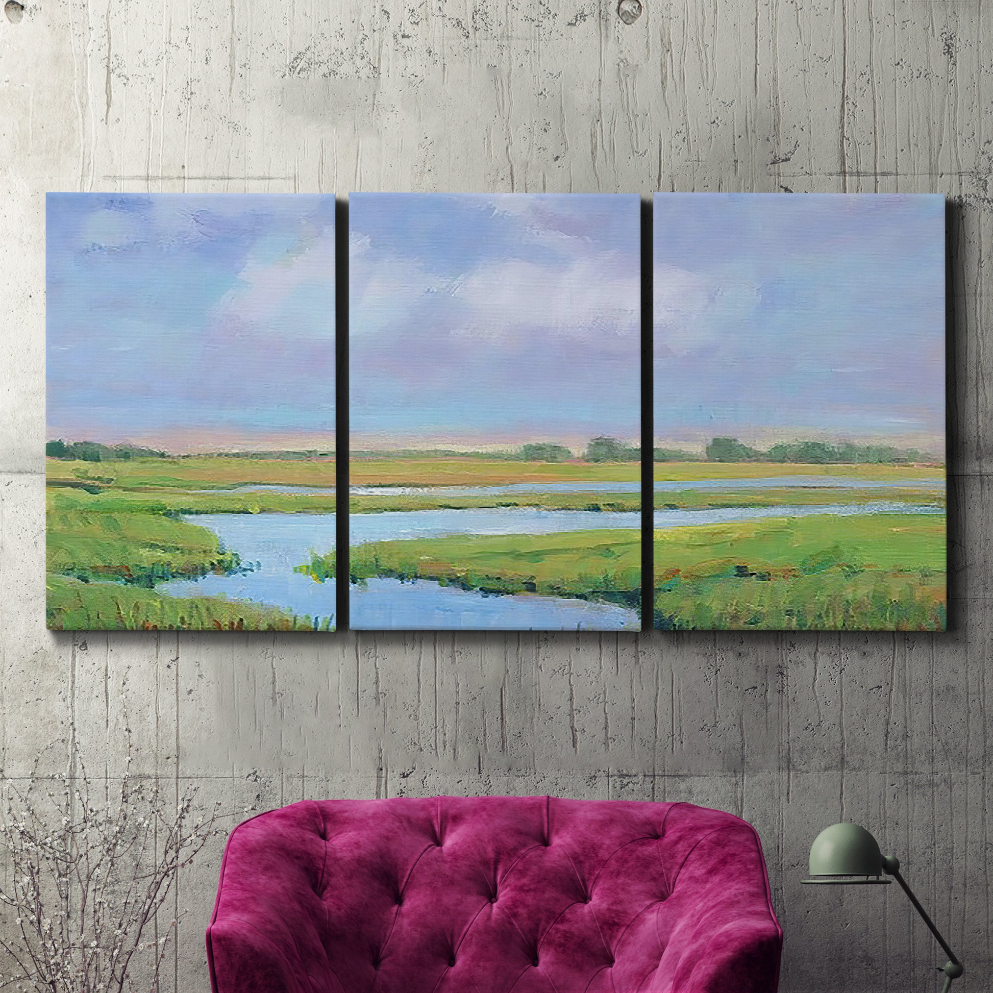 Three-panel canvas wall art featuring summer marshland with tall grasses, displayed in a living room above a suede accent chair.