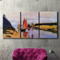 Three-panel canvas wall art featuring stone breakwater at low tide, displayed in a living room above a suede accent chair.