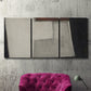 Three-panel canvas wall art featuring geometric abstract roadway motif, displayed in a living room above a suede accent chair.