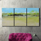 Three-panel canvas wall art featuring abstract terrace landscape view, displayed in a living room above a suede accent chair.