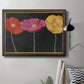 Contemporary poppy flower artwork in an ornate mahogany wood frame with gold liner displayed in a neutral interior setting.