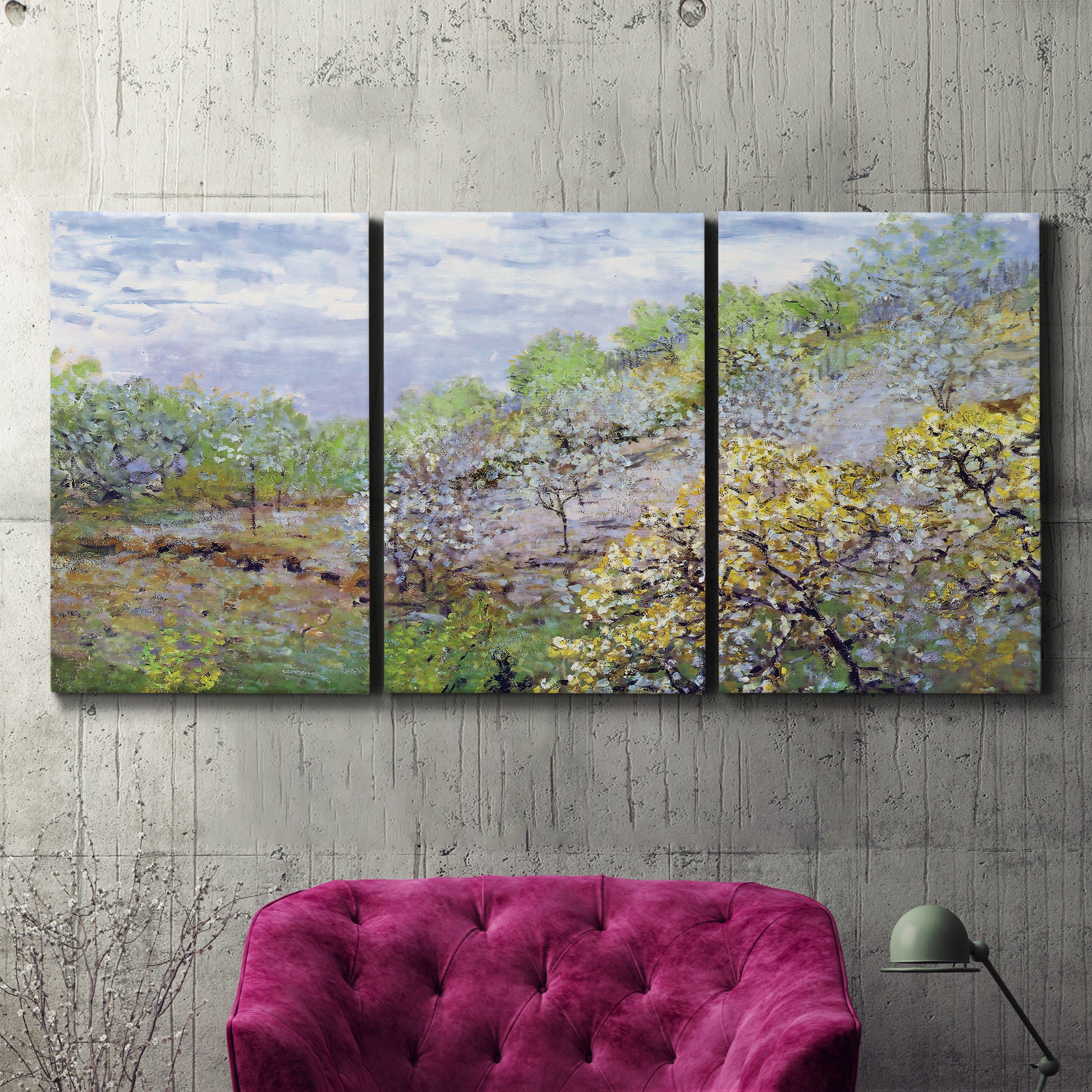 Three-panel canvas wall art featuring spring orchard in full bloom, displayed in a living room above a suede accent chair.