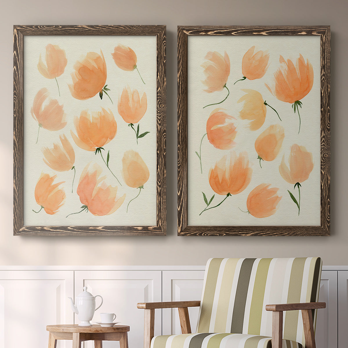 Set of two walnut barnwood framed canvas prints depicting two airy watercolor floral paintings featuring loose peach-orange tulip-like blossoms above a sideboard in a cozy sitting room.