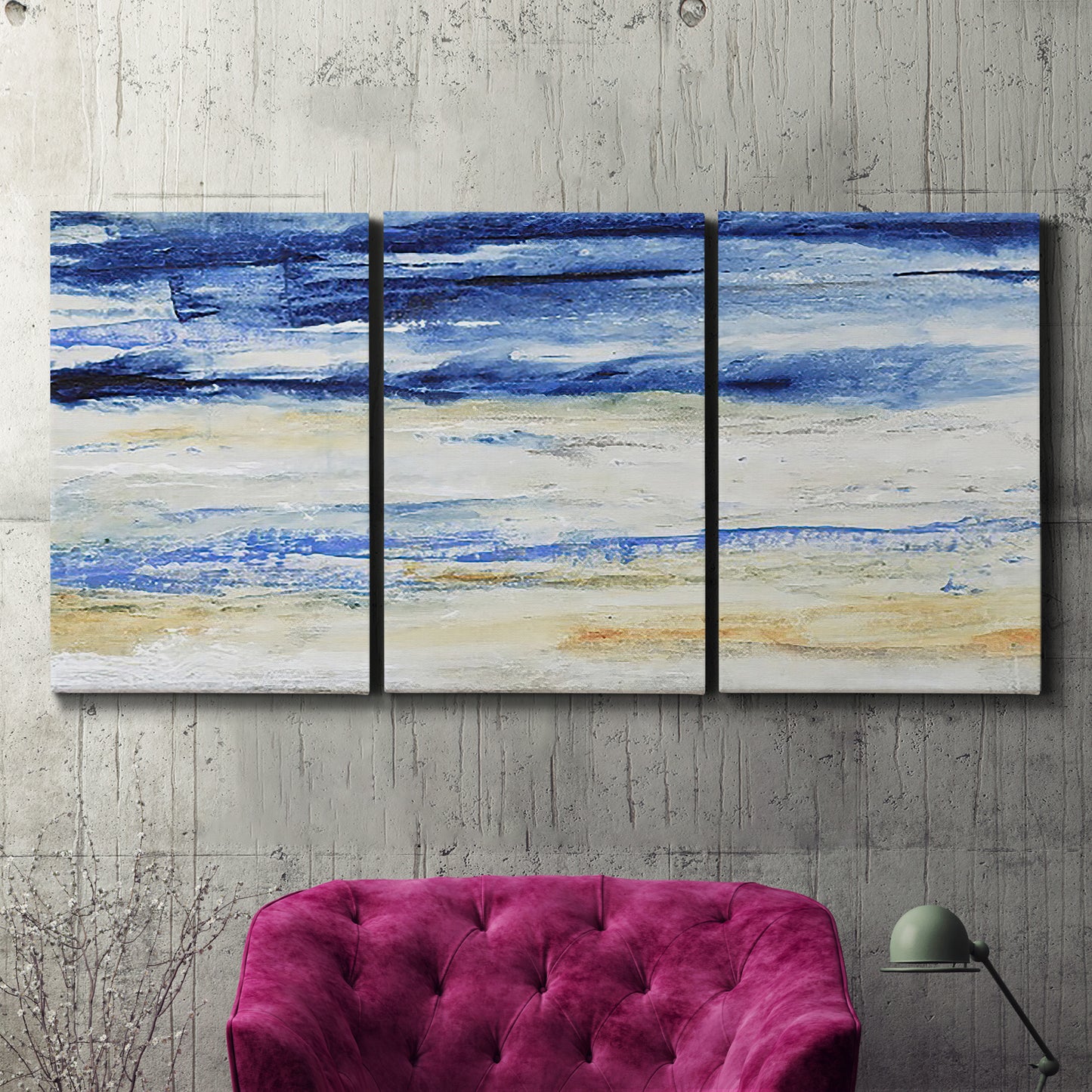 Three-panel canvas wall art featuring turbulent abstract ocean wave motion, displayed in a living room above a suede accent chair.