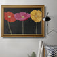Contemporary poppy flower artwork in an ornate traditional gold frame displayed in a neutral interior setting.