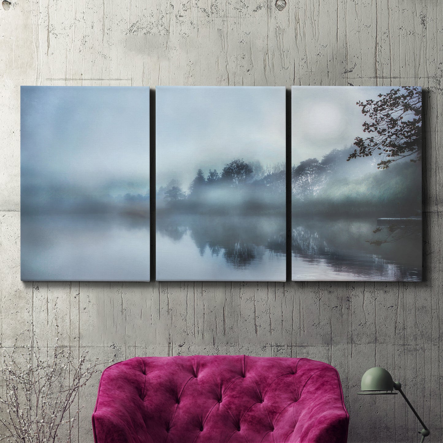 Three-panel canvas wall art featuring calm waters at sunrise photograph, displayed in a living room above a suede accent chair.