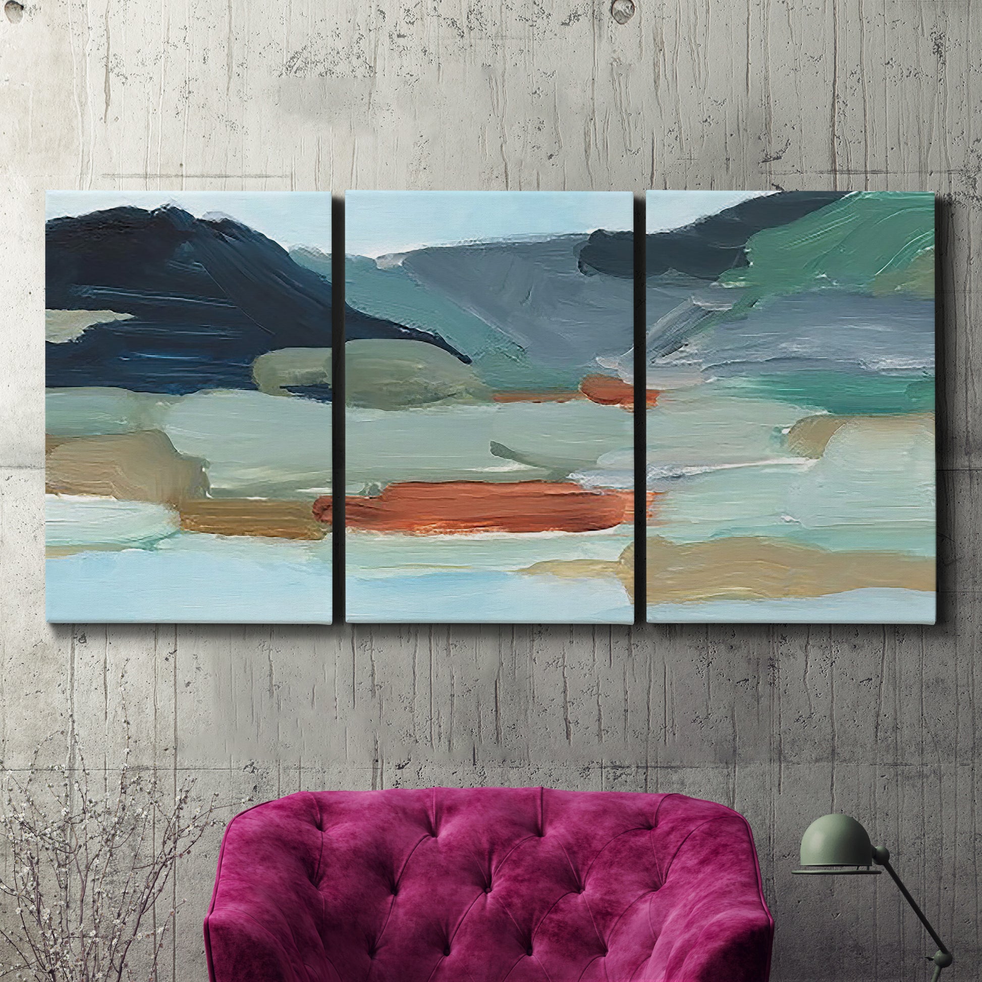 Three-panel canvas wall art featuring vibrant abstract with dramatic motion, displayed in a living room above a suede accent chair.