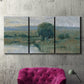 Three-panel canvas wall art featuring riverbank landscape with reflections, displayed in a living room above a suede accent chair.