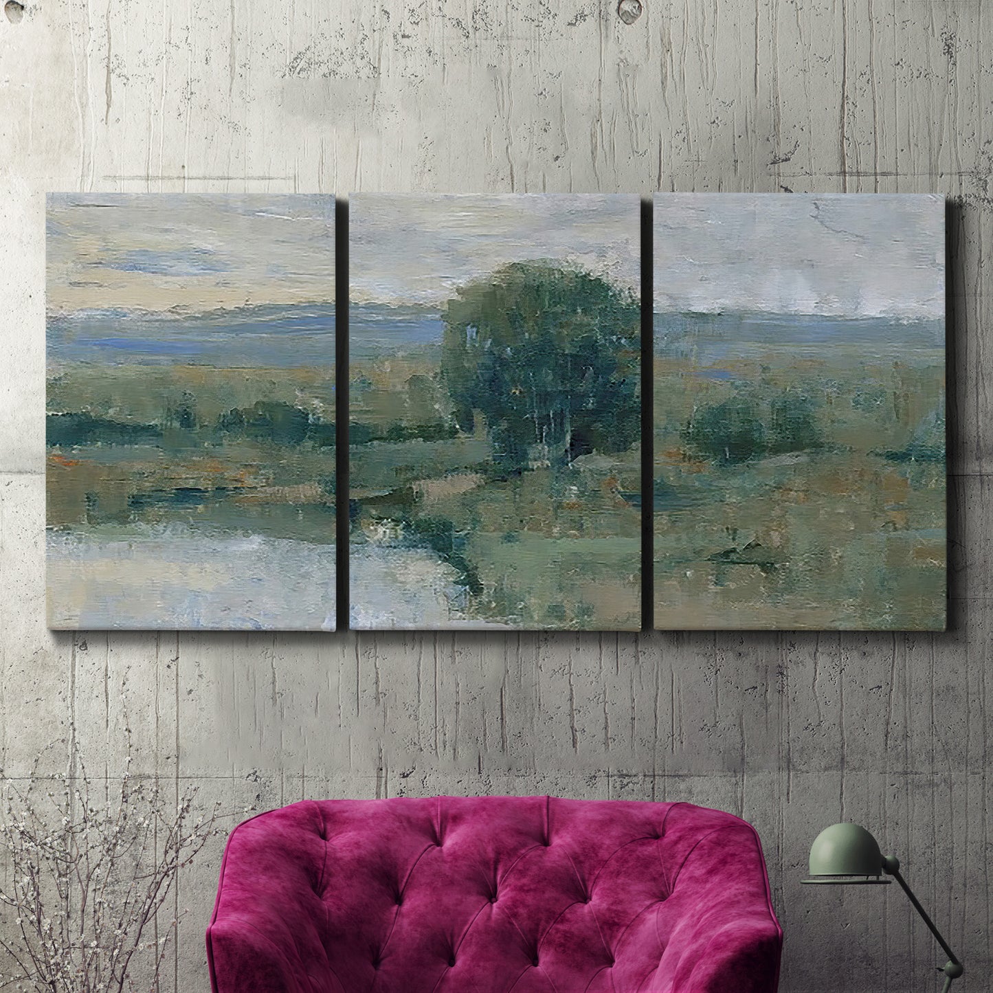 Three-panel canvas wall art featuring riverbank landscape with reflections, displayed in a living room above a suede accent chair.