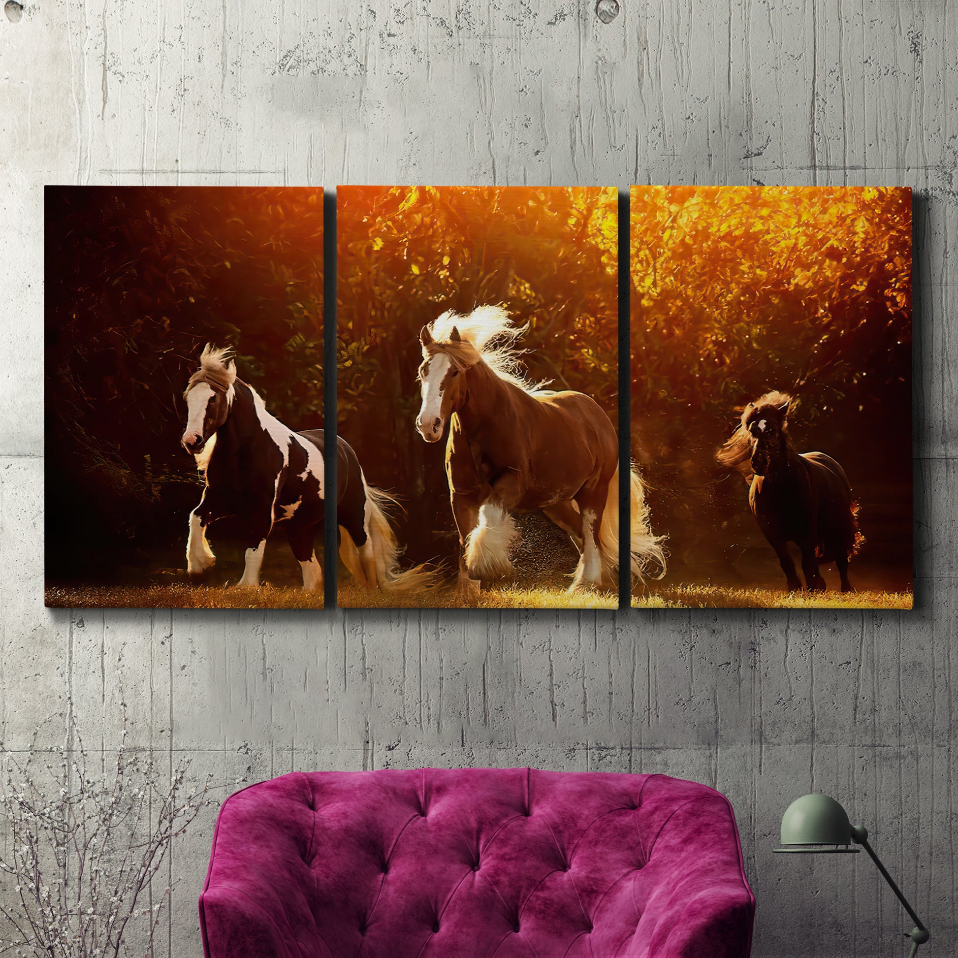 Three-panel canvas wall art featuring running horses across open field, displayed in a living room above a suede accent chair.