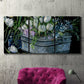 Three-panel canvas wall art featuring colorful wild tulips in bloom, displayed in a living room above a suede accent chair.