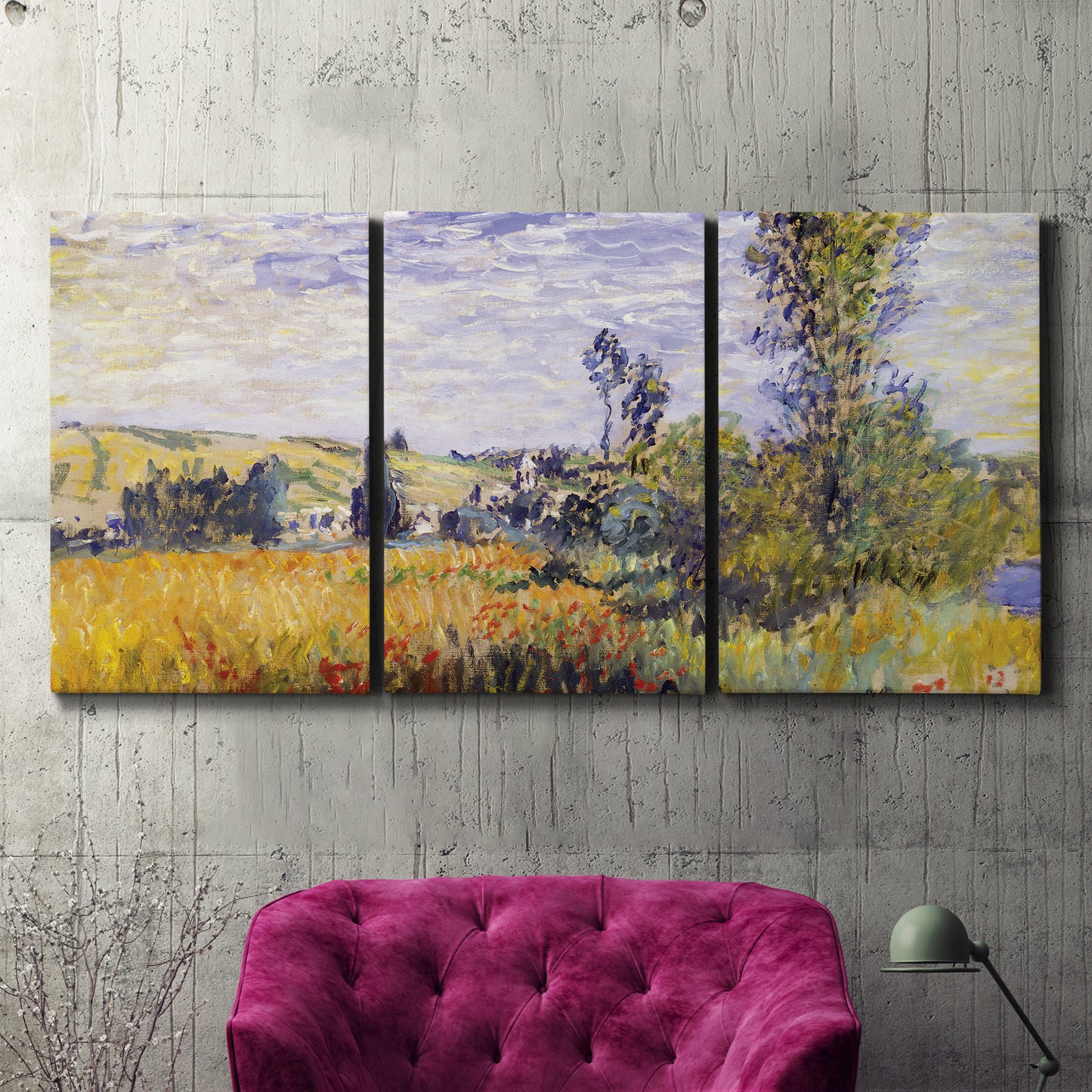 Three-panel canvas wall art featuring river village landscape with hills, displayed in a living room above a suede accent chair.