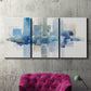 Three-panel canvas wall art featuring minimal urban skyline watercolor, displayed in a living room above a suede accent chair.