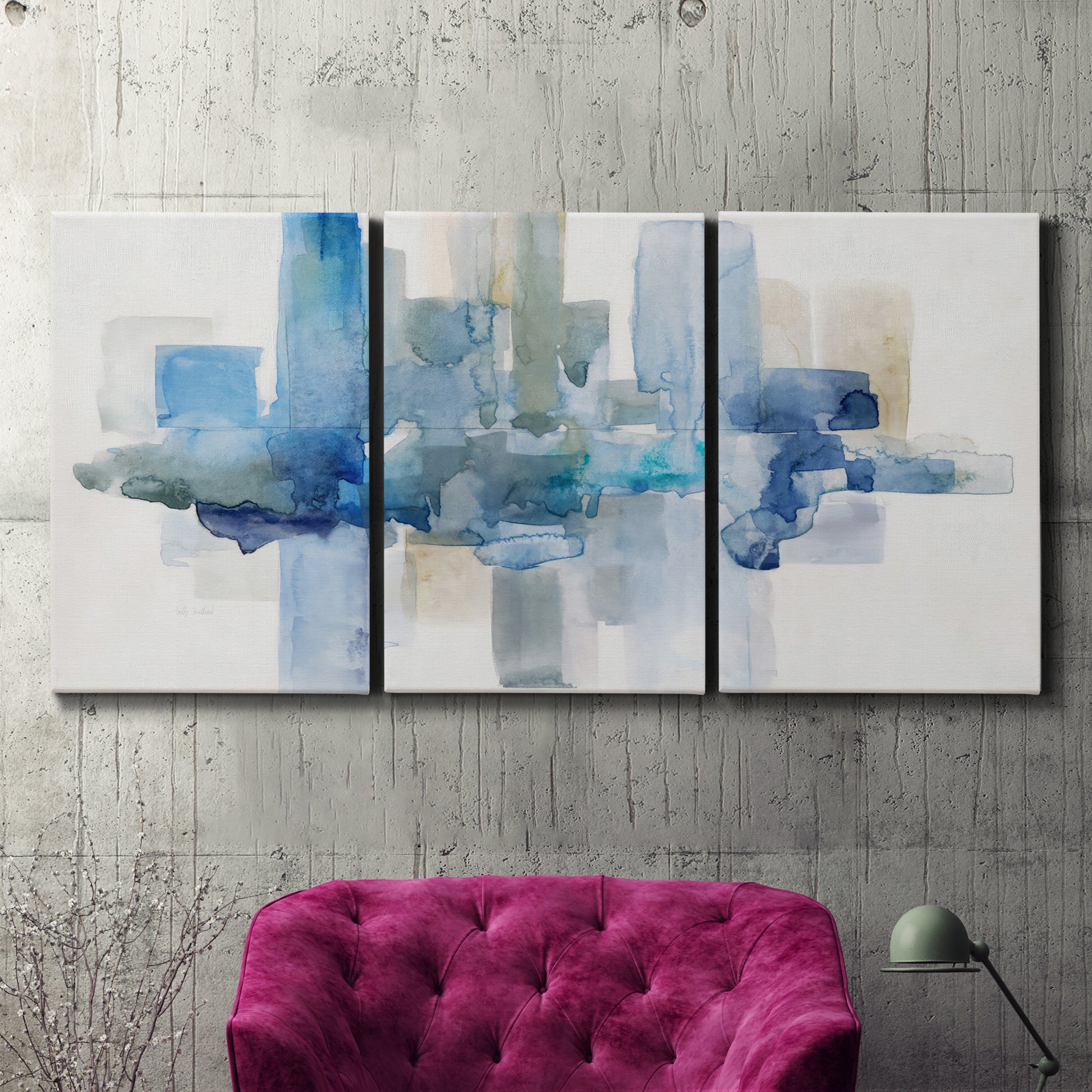 Three-panel canvas wall art featuring minimal urban skyline watercolor, displayed in a living room above a suede accent chair.
