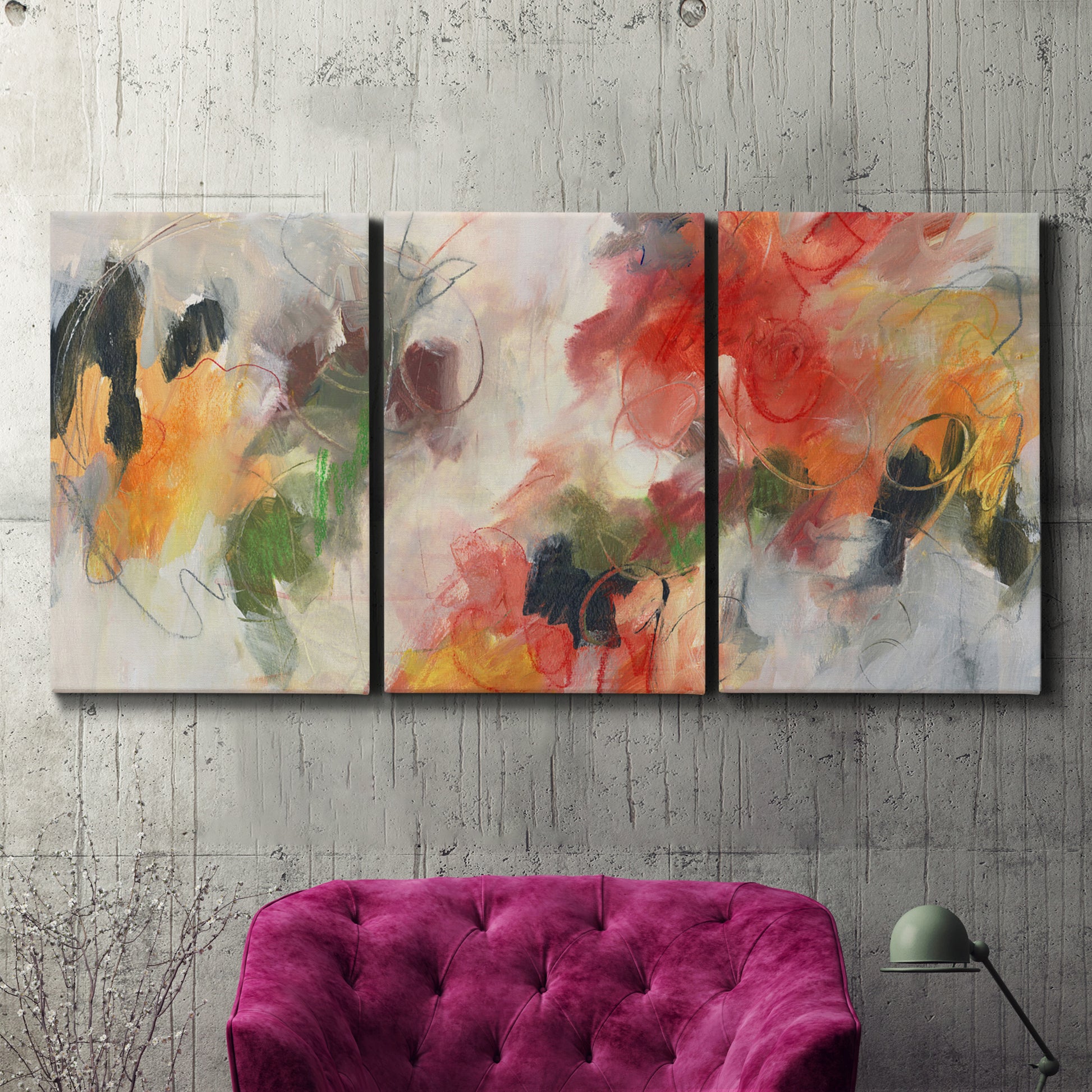 Three-panel canvas wall art featuring abstract floral color composition, displayed in a living room above a suede accent chair.