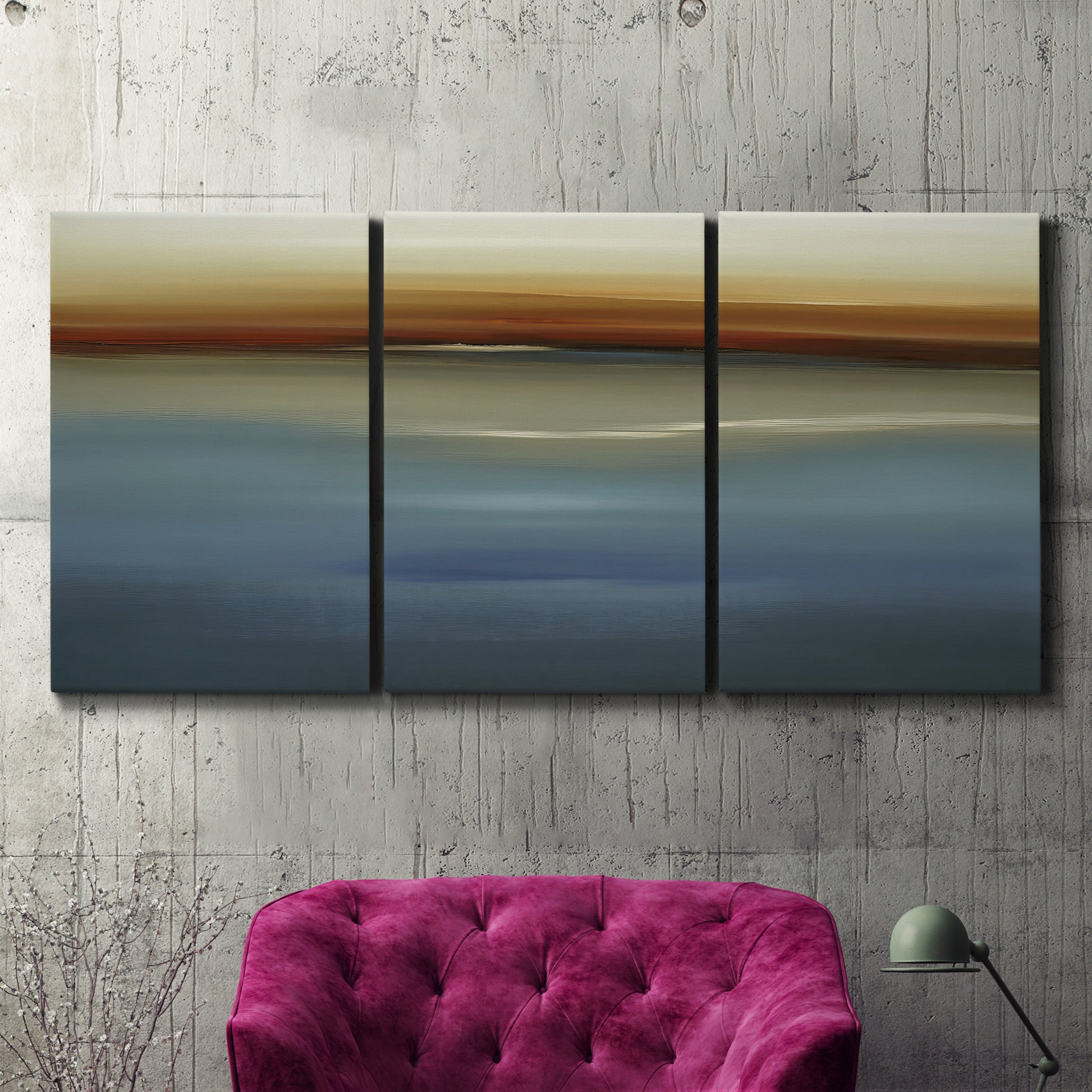 Three-panel canvas wall art featuring horizontal abstract coastal color bands, displayed in a living room above a suede accent chair.