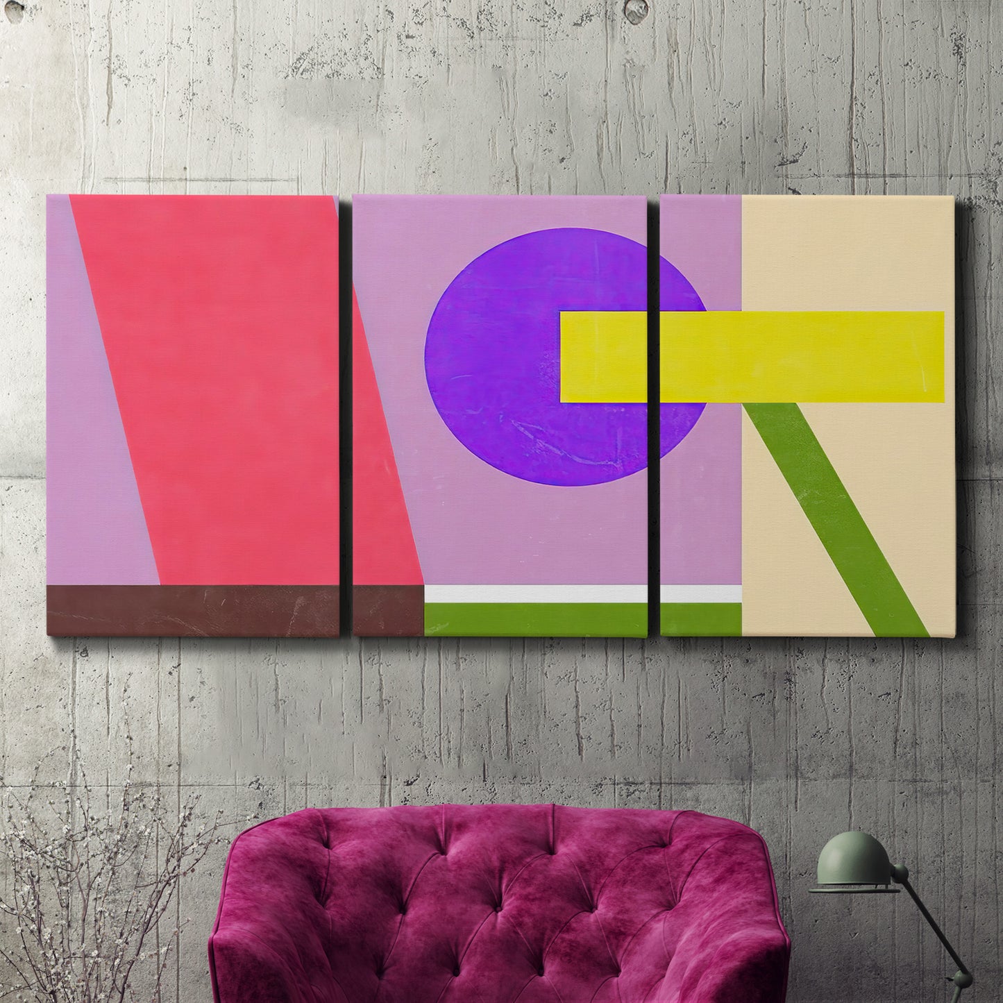 Three-panel canvas wall art featuring bold geometric color abstraction, displayed in a living room above a suede accent chair.