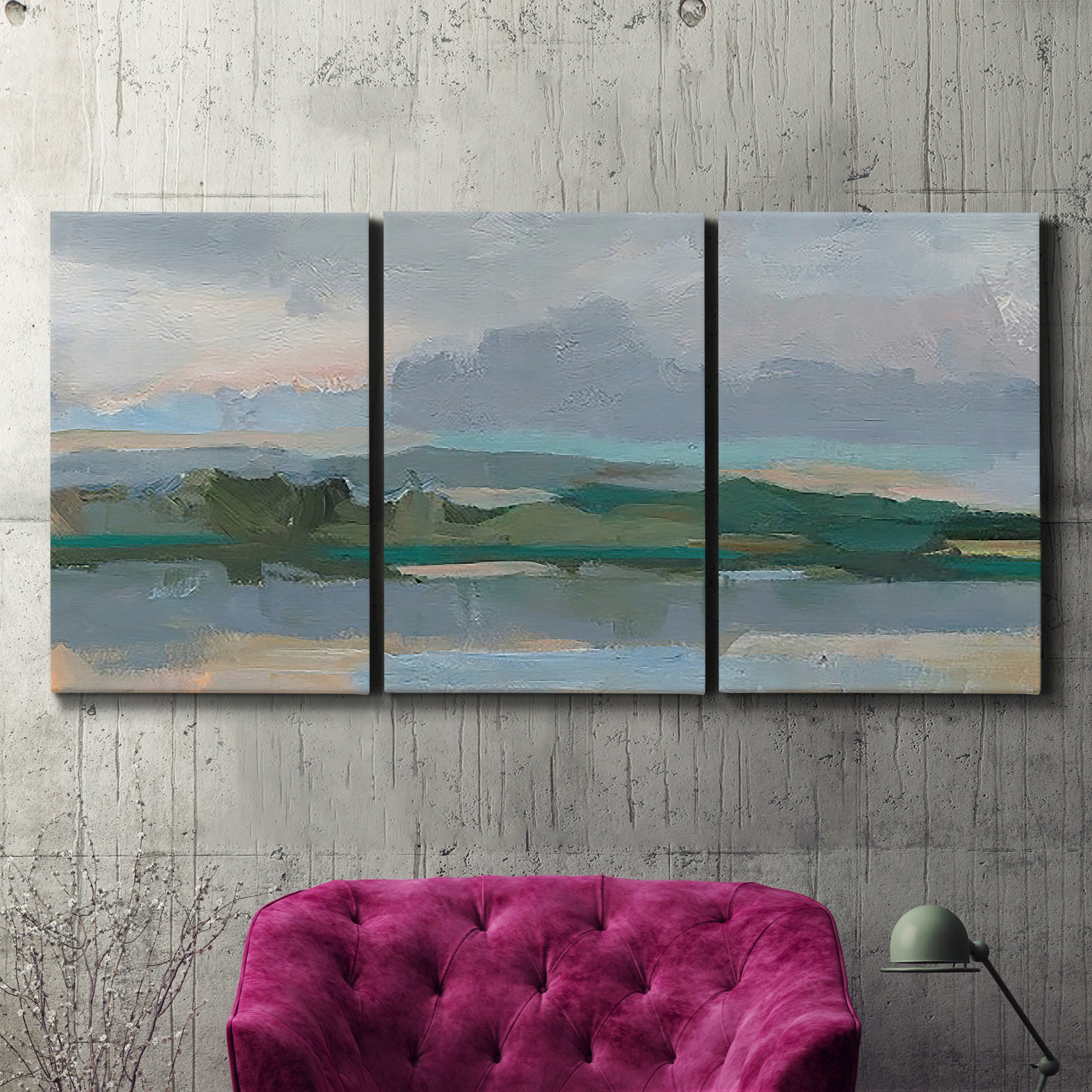 Three-panel canvas wall art featuring twilight landscape with fading light, displayed in a living room above a suede accent chair.