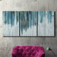 Three-panel canvas wall art featuring wide pastoral valley landscape, displayed in a living room above a suede accent chair.