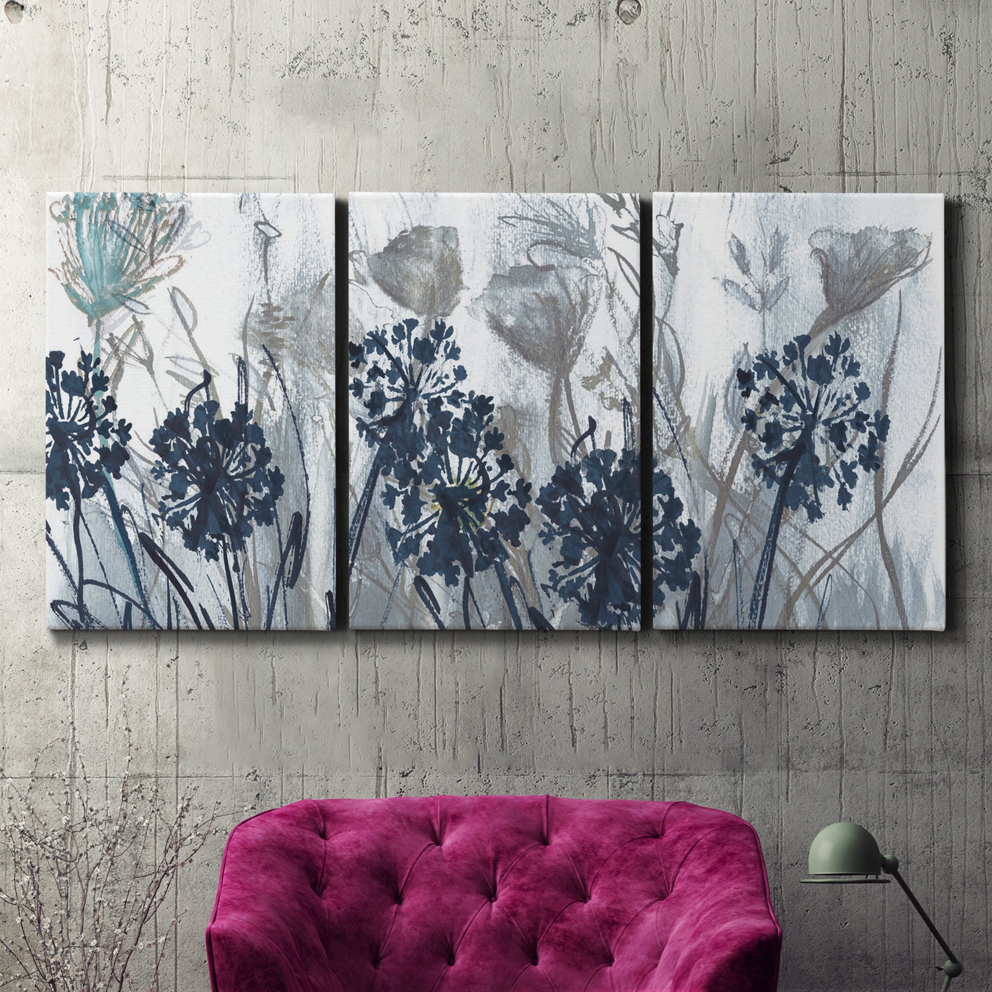 Three-panel canvas wall art featuring indigo floral abstraction, displayed in a living room above a suede accent chair.