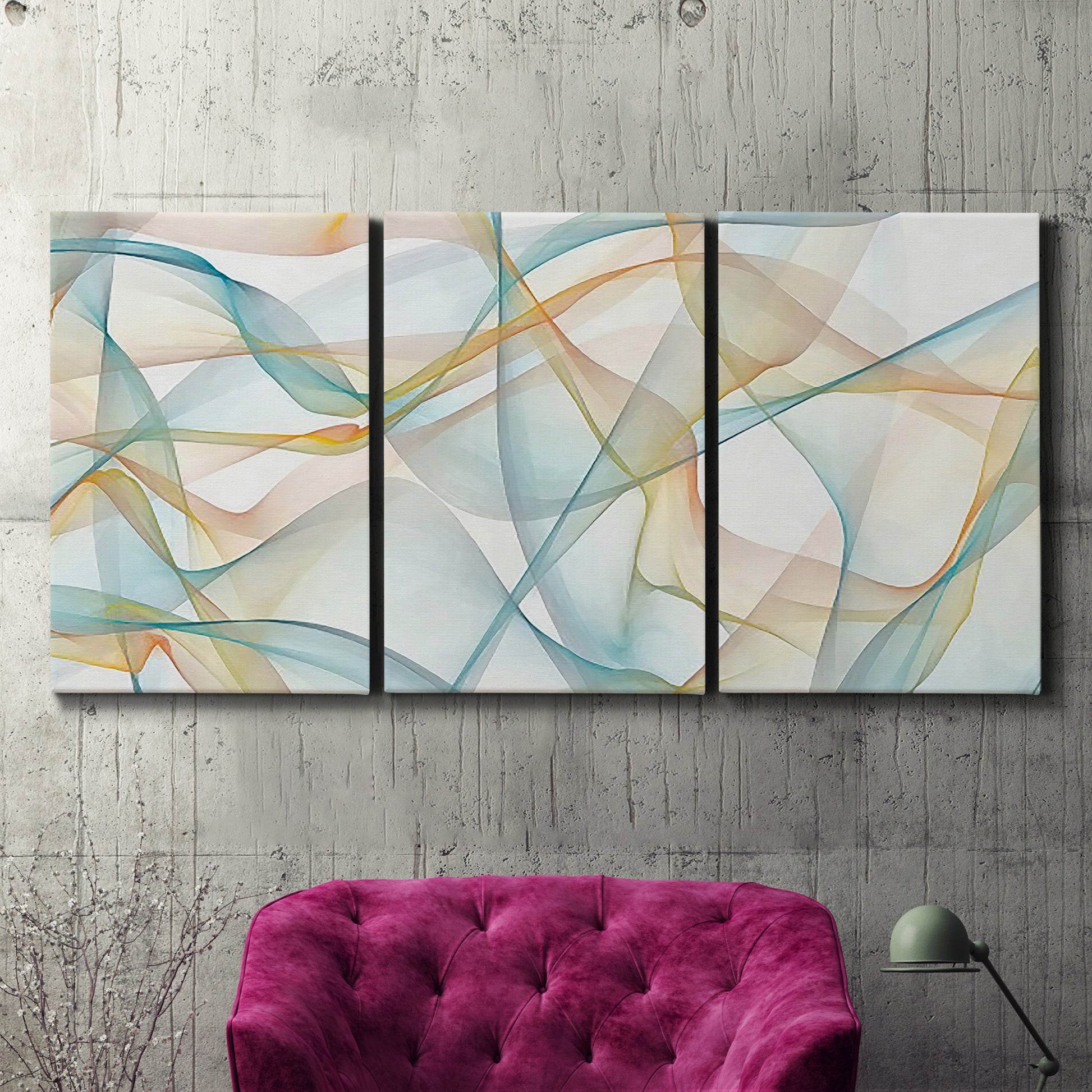 Three-panel canvas wall art featuring flowing abstract curves and wave patterns, displayed in a living room above a suede accent chair.