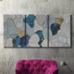 Three-panel canvas wall art featuring mid century geometric pink abstraction, displayed in a living room above a suede accent chair.