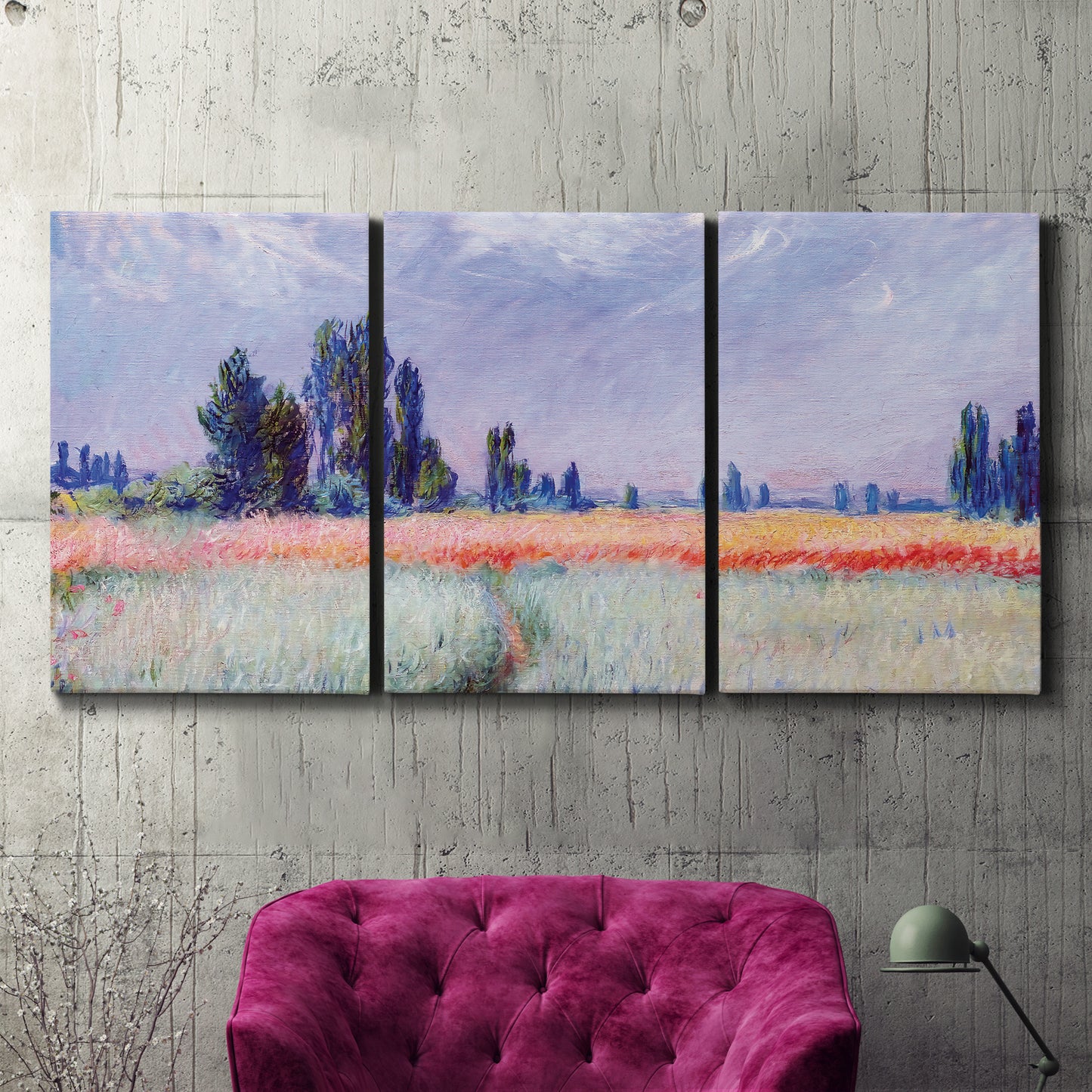 Three-panel canvas wall art featuring flowering field with poppies, displayed in a living room above a suede accent chair.
