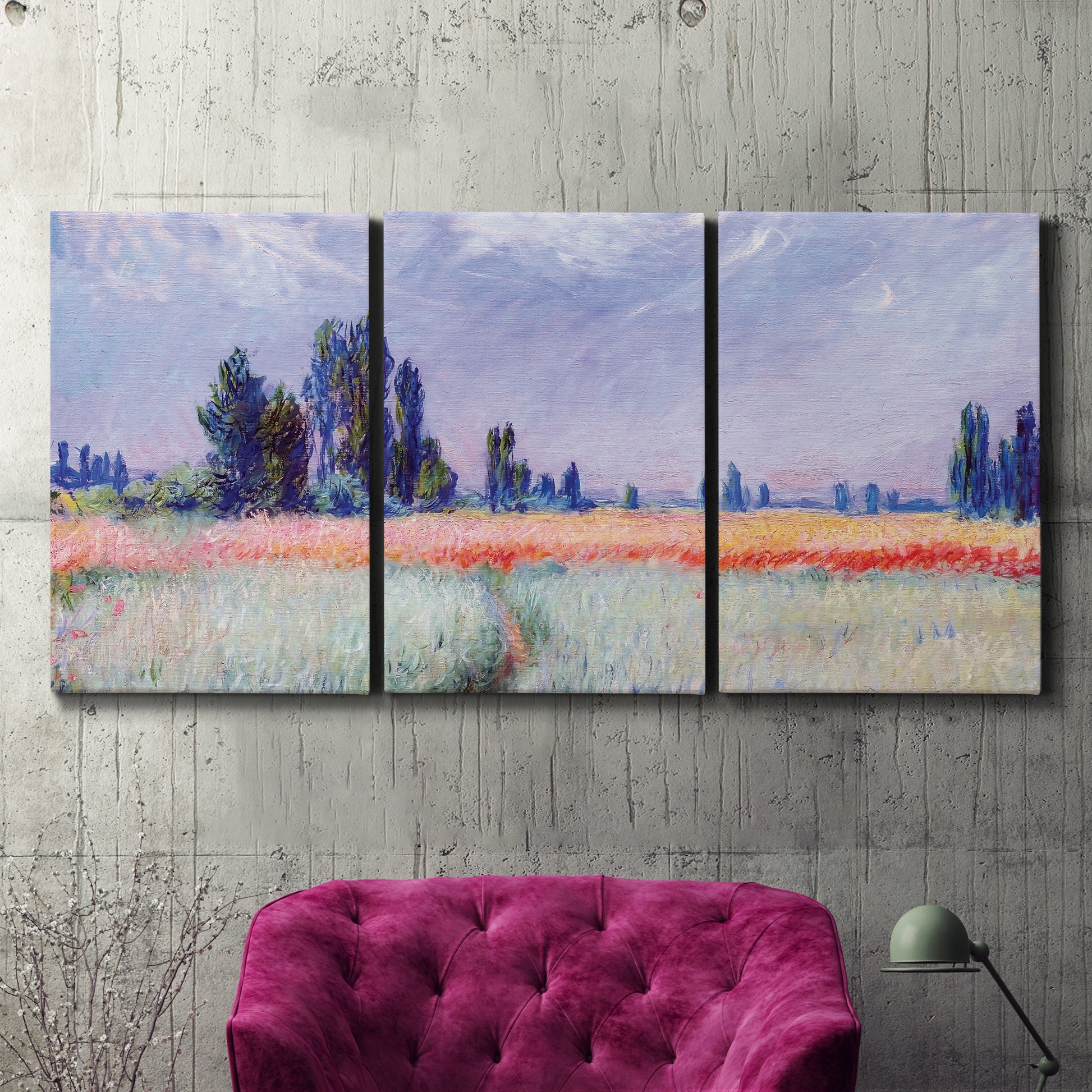 Three-panel canvas wall art featuring flowering field with poppies, displayed in a living room above a suede accent chair.