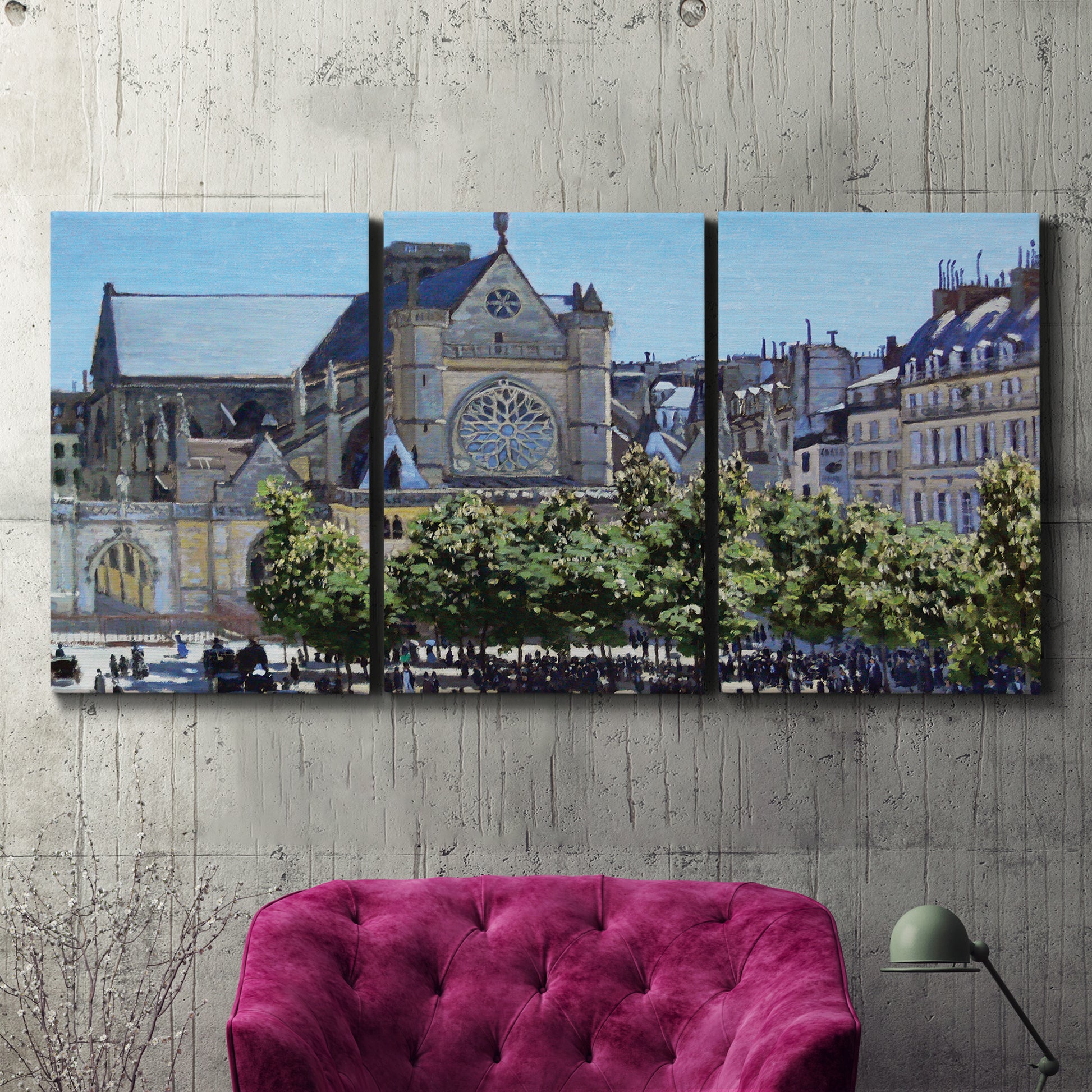Three-panel canvas wall art featuring gothic church within city setting, displayed in a living room above a suede accent chair.