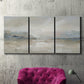 Three-panel canvas wall art featuring soft abstract horizon haze, displayed in a living room above a suede accent chair.