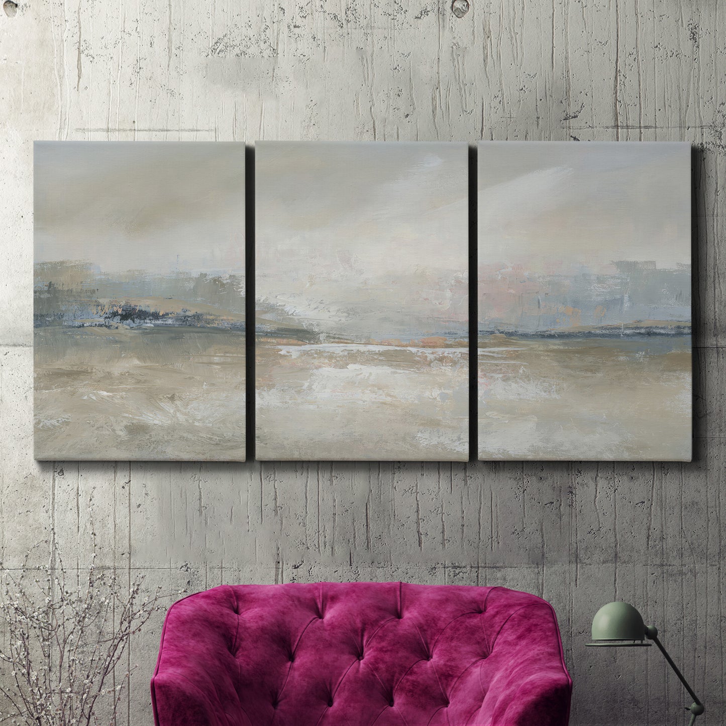 Three-panel canvas wall art featuring soft abstract horizon haze, displayed in a living room above a suede accent chair.