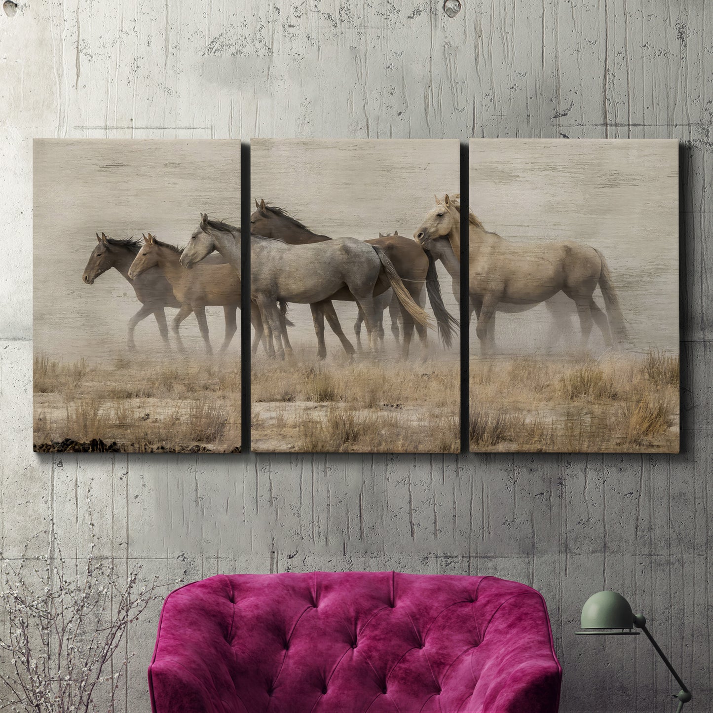 Three-panel canvas wall art featuring wild horses roaming open terrain, displayed in a living room above a suede accent chair.